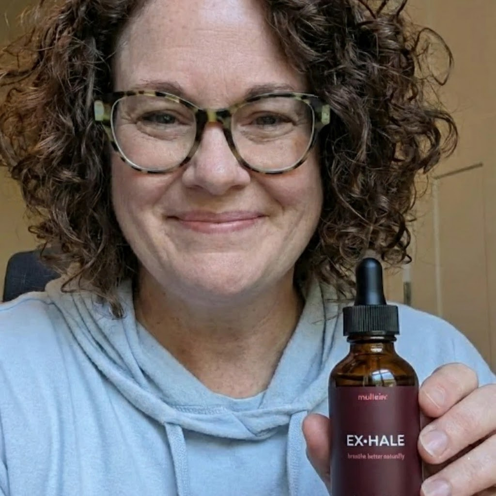 Happy woman holding a bottle of botanical tincture